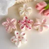Pastel floral hair clips arranged in a divided tray